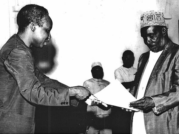 first president of tanzania julias nyerere and first president of zanzibar adeid aman karume exchangung documents of unity